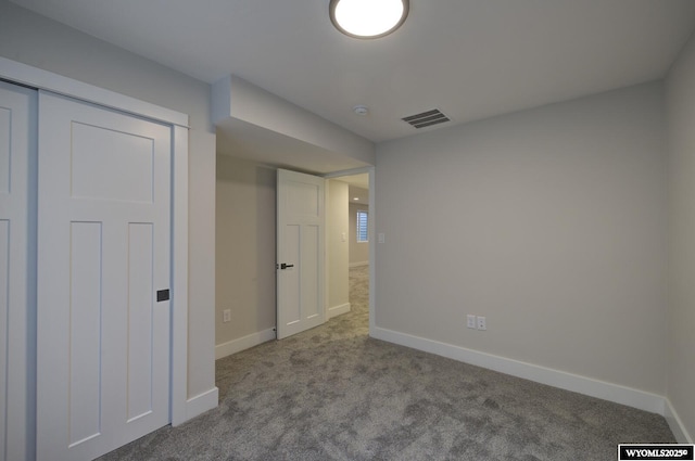 unfurnished bedroom featuring carpet flooring and baseboards