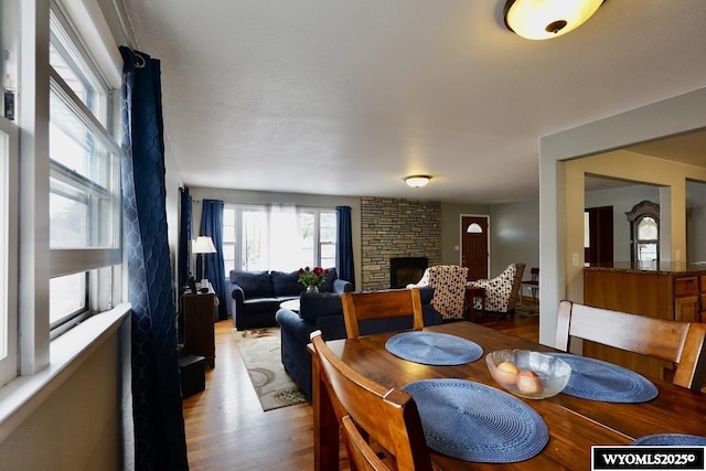 dining area featuring wood finished floors and a fireplace