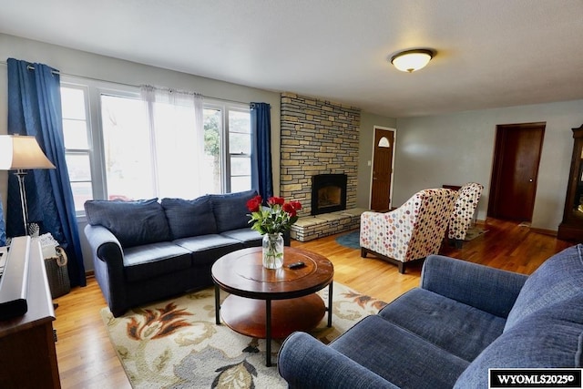 living area with wood finished floors and a fireplace