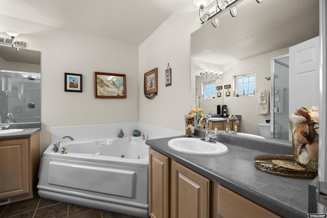 bathroom featuring a stall shower, two vanities, a whirlpool tub, and tile patterned floors