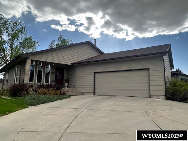 view of front of property featuring an attached garage and driveway