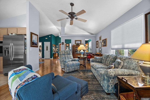 living area with lofted ceiling, ceiling fan, and wood finished floors