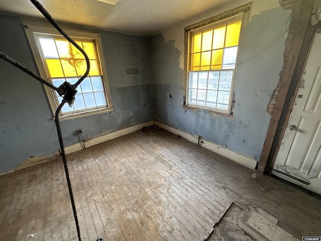 219 W Franklin St, Morrill, NE 69358 - unfurnished bedroom featuring multiple windows and wood-type flooring