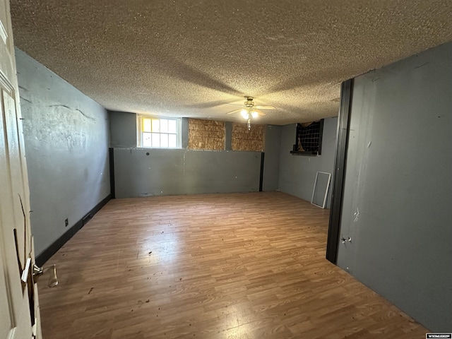 219 W Franklin St, Morrill, NE 69358 - basement featuring wood finished floors, a ceiling fan, and a textured ceiling