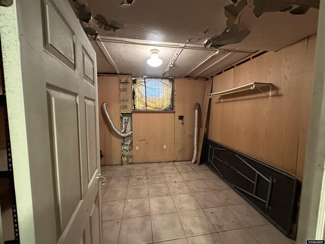 219 W Franklin St, Morrill, NE 69358 - below grade area featuring light tile patterned flooring and wooden walls