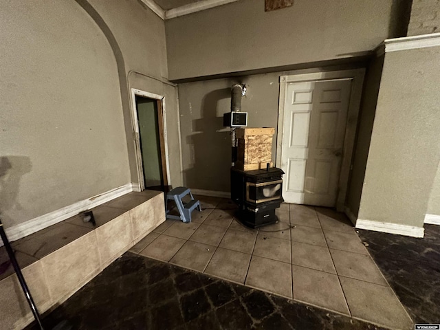 219 W Franklin St, Morrill, NE 69358 - detailed view of a wood stove, arched walkways, baseboards, a textured wall, and ornamental molding