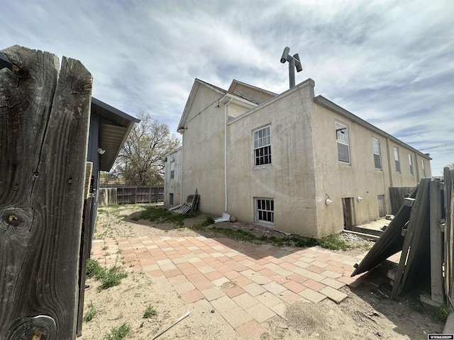 219 W Franklin St, Morrill, NE 69358 - view of side of property featuring stucco siding, fence, and a patio area
