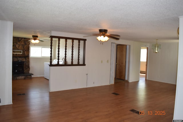 unfurnished living room with a ceiling fan, a textured ceiling, wood finished floors, and a chandelier