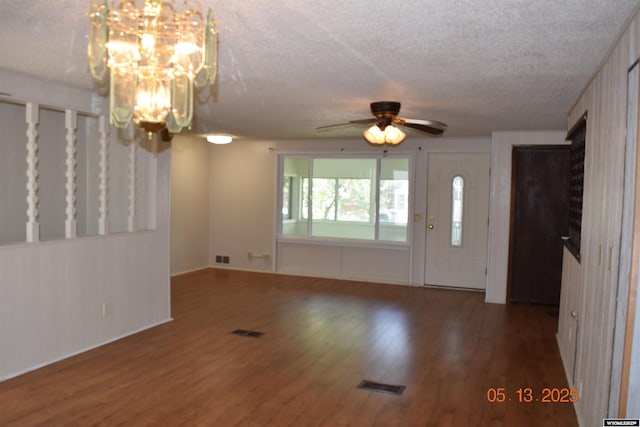 foyer entrance featuring a chandelier, a textured ceiling, wood finished floors, a ceiling fan, and baseboards