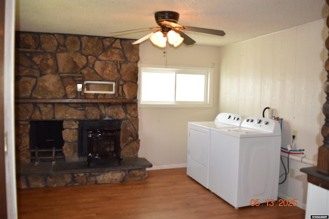 laundry room featuring separate washer and dryer, a ceiling fan, wood finished floors, a textured ceiling, and baseboards