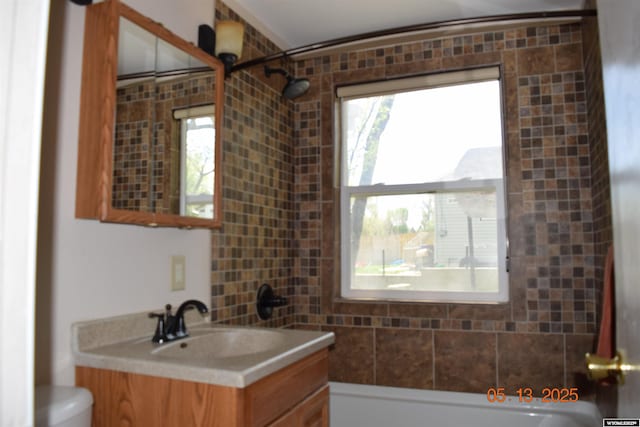full bath featuring toilet, washtub / shower combination, and vanity