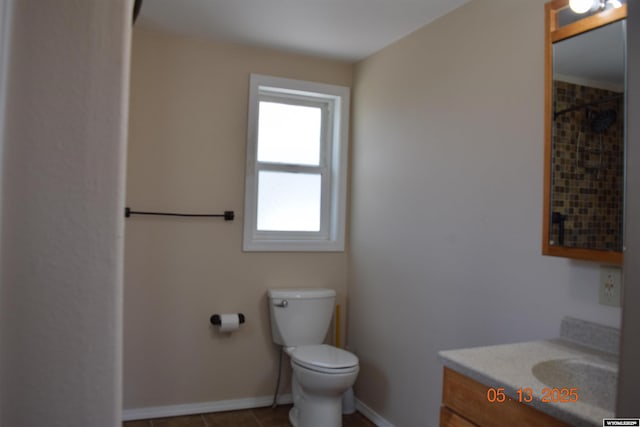bathroom with vanity, toilet, baseboards, and tile patterned floors
