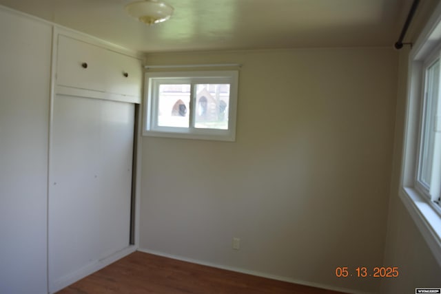 unfurnished bedroom featuring wood finished floors and a closet