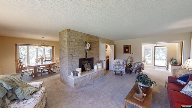living area featuring a fireplace, a textured ceiling, and carpet floors