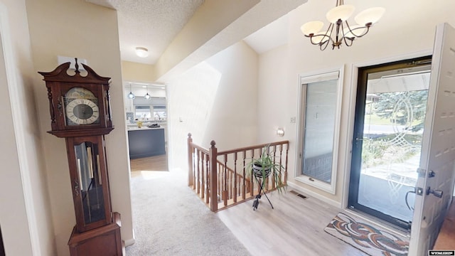 foyer featuring a chandelier, light wood-style flooring, and baseboards
