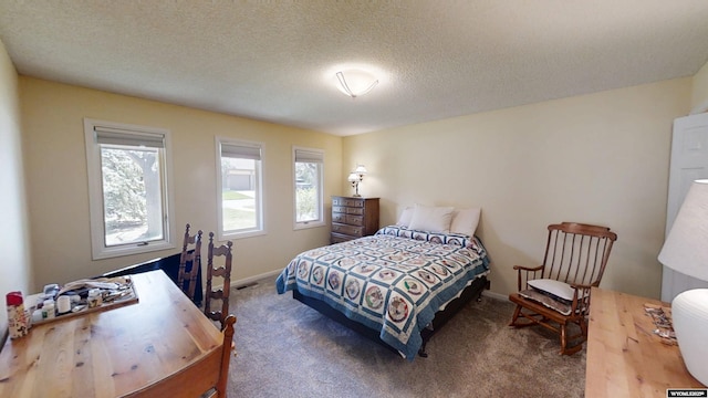 bedroom featuring carpet flooring, baseboards, and a textured ceiling