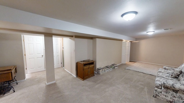 finished basement with light carpet and baseboards