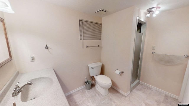 bathroom with toilet, an enclosed shower, and vanity