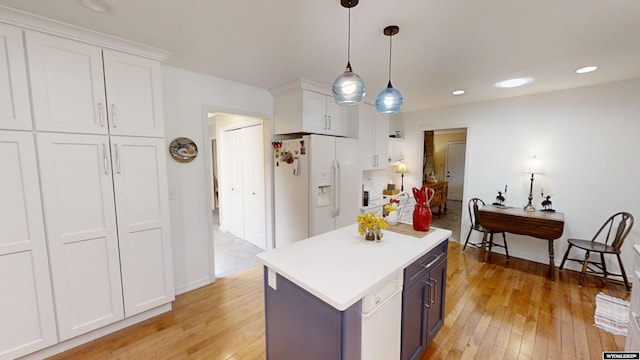 kitchen with white fridge with ice dispenser, light wood-style floors, white cabinetry, light countertops, and recessed lighting