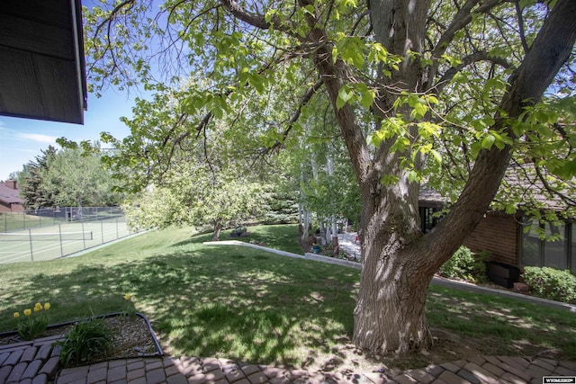view of yard with a tennis court
