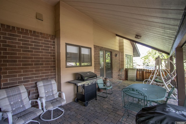 view of patio / terrace featuring a grill and fence