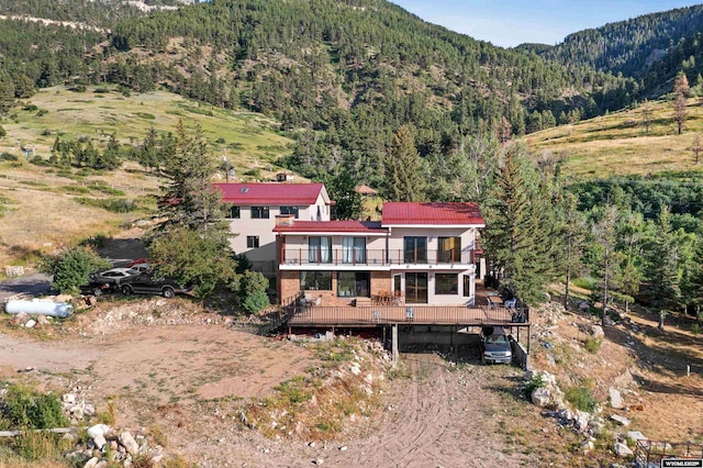 view from above of property with a heavily wooded area and mountains