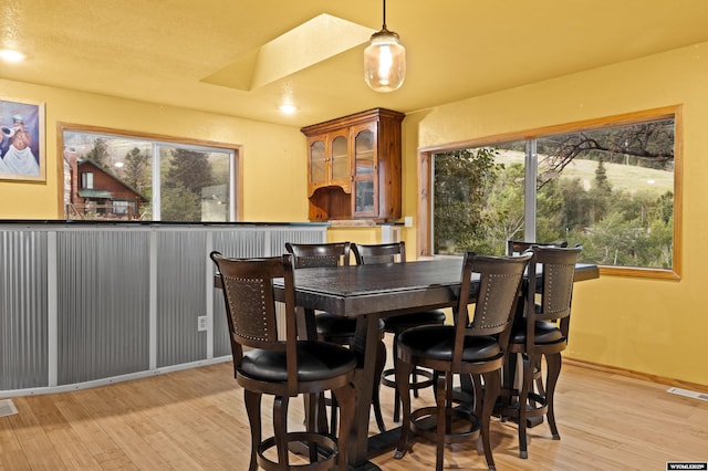 dining room with light wood-style flooring and baseboards
