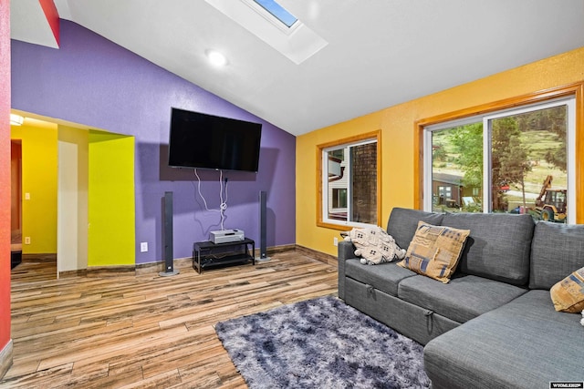 living area featuring a skylight, lofted ceiling, wood finished floors, baseboards, and recessed lighting