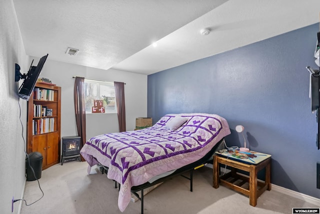 104 Canyon Hollow Dr, Evanston, WY 82930 - carpeted bedroom featuring a textured wall, a textured ceiling, and baseboards