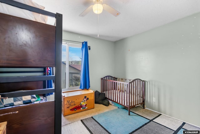 104 Canyon Hollow Dr, Evanston, WY 82930 - bedroom featuring a ceiling fan, carpet, and a nursery area
