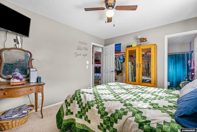 104 Canyon Hollow Dr, Evanston, WY 82930 - bedroom with carpet flooring, ceiling fan, a textured ceiling, baseboards, and a spacious closet