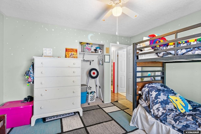 104 Canyon Hollow Dr, Evanston, WY 82930 - bedroom featuring a textured ceiling, carpet flooring, and a ceiling fan