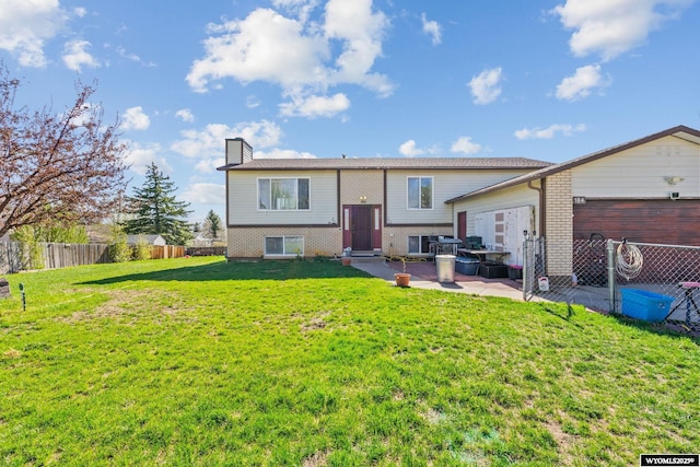 104 Canyon Hollow Dr, Evanston, WY 82930 - back of property with a patio, a chimney, and brick siding