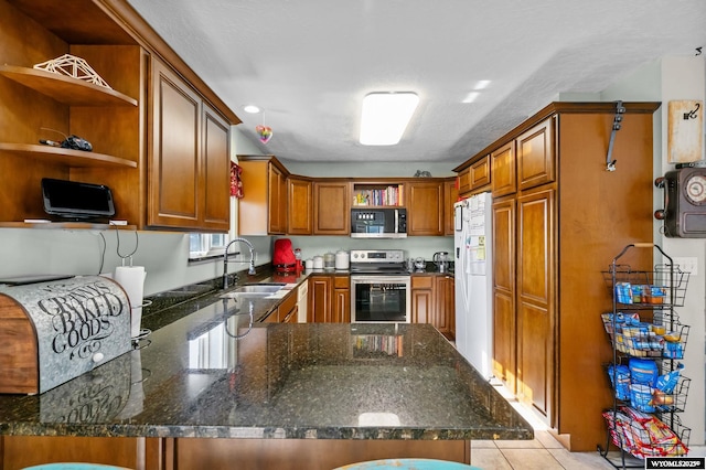 104 Canyon Hollow Dr, Evanston, WY 82930 - kitchen with appliances with stainless steel finishes, open shelves, a sink, a peninsula, and brown cabinets