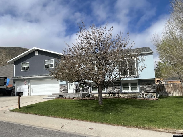2715 Colorado Dr, Green River, WY 82935 - traditional-style house featuring a garage, stone siding, concrete driveway, and stucco siding