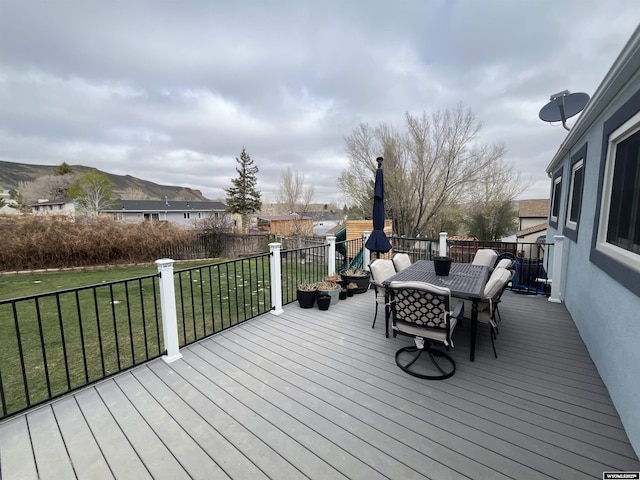 2715 Colorado Dr, Green River, WY 82935 - deck featuring outdoor dining area and a lawn
