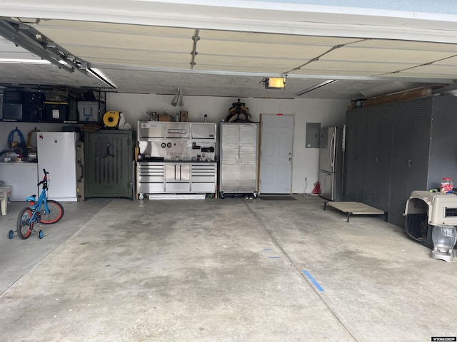 2715 Colorado Dr, Green River, WY 82935 - garage featuring freestanding refrigerator and a garage door opener