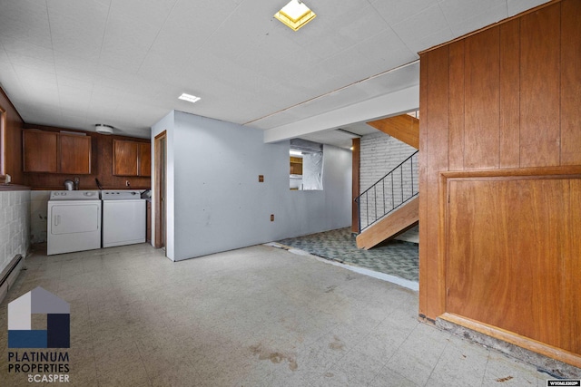 basement with independent washer and dryer, light floors, and stairway