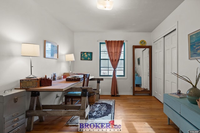 office area featuring light wood finished floors and baseboards