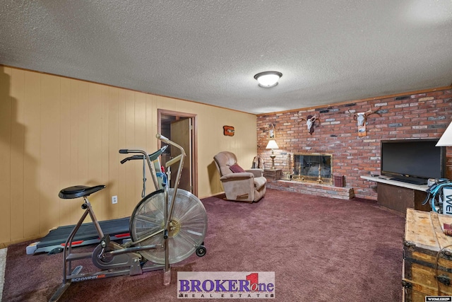 workout room with carpet floors and a brick fireplace