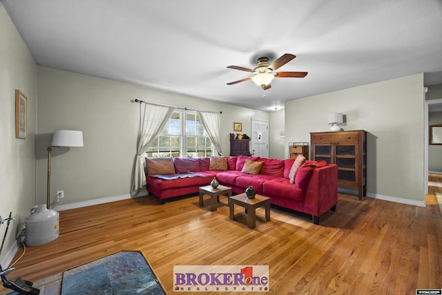 living room with ceiling fan, light wood-style flooring, and baseboards