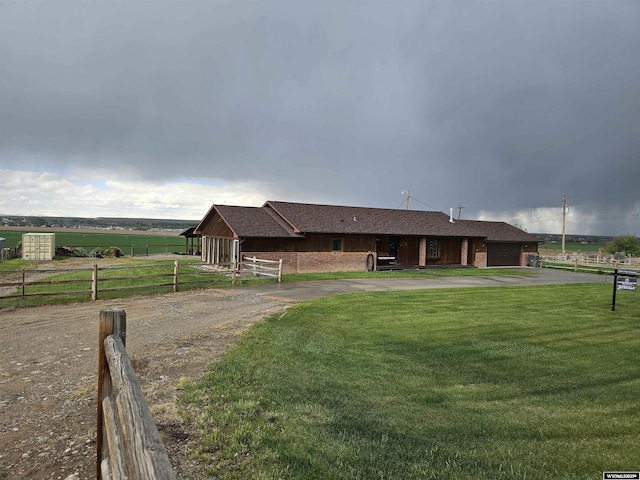 1008 N Rd 11, Worland, WY 82401 - ranch-style house with a garage, driveway, a rural view, and roof with shingles
