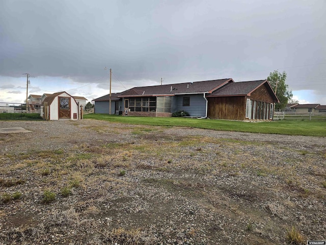 1008 N Rd 11, Worland, WY 82401 - rear view of house featuring a storage shed and an outdoor structure