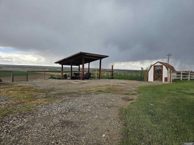 1008 N Rd 11, Worland, WY 82401 - view of yard featuring an outbuilding, a storage unit, and fence