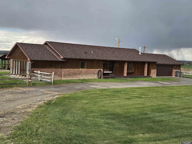 1008 N Rd 11, Worland, WY 82401 - view of front of house featuring driveway, a garage, and a shingled roof