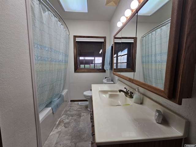 1008 N Rd 11, Worland, WY 82401 - full bathroom featuring toilet, vanity, shower / bath combo with shower curtain, and stone finish flooring