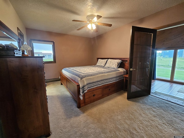 1008 N Rd 11, Worland, WY 82401 - bedroom featuring a textured ceiling, access to outside, carpet, and ceiling fan