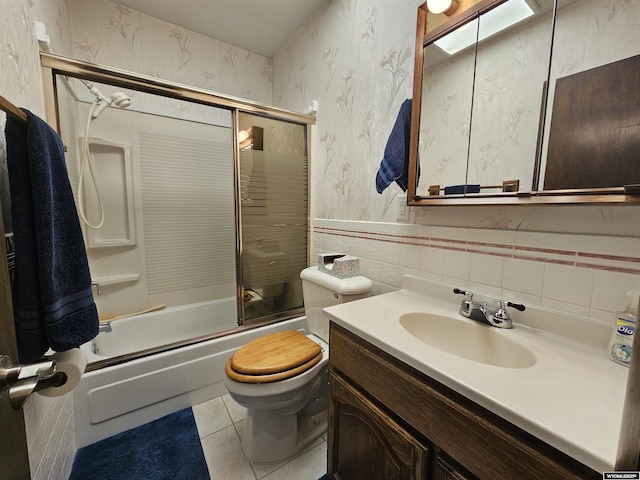 1008 N Rd 11, Worland, WY 82401 - bathroom with wallpapered walls, tile patterned floors, bath / shower combo with glass door, vanity, and toilet
