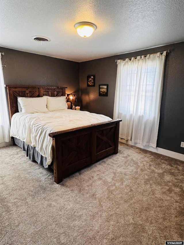 101 Pebble Ln, Torrington, WY 82240 - bedroom with a textured ceiling and light carpet