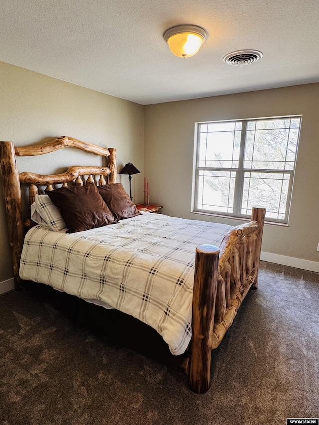 101 Pebble Ln, Torrington, WY 82240 - bedroom featuring carpet, a textured ceiling, and baseboards